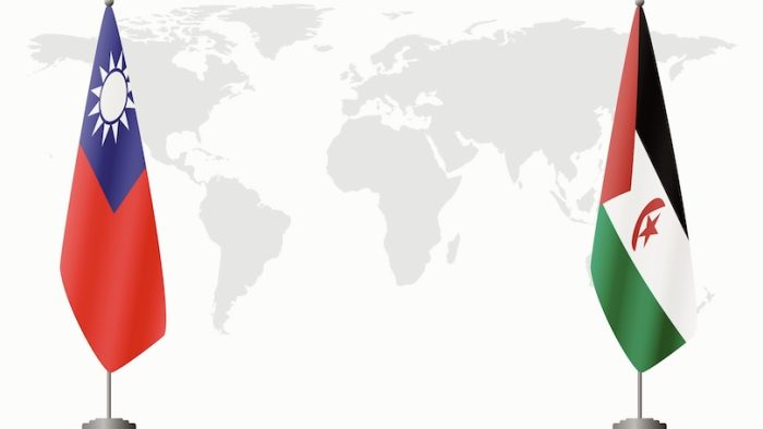 Taiwan and Sahrawi Arab Democratic Republic flags for official meeting against background of world map.