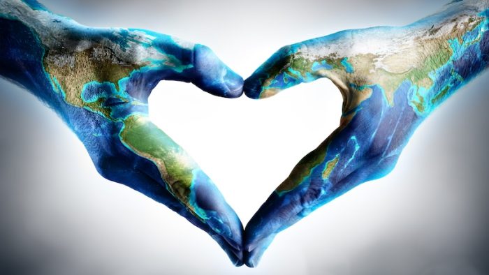 earth's day celebration - hands shaped heart with world map - elements of this image furnished by NASA